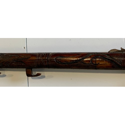 115 - Vintage Indonesian Carved Bone Blowpipe Depicting A Mythical Dragon Like Beast
77 cms in length