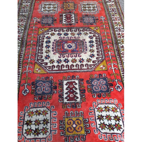 75 - Handmade Rug. Red Ground with central Lozenges. 200CM X 133