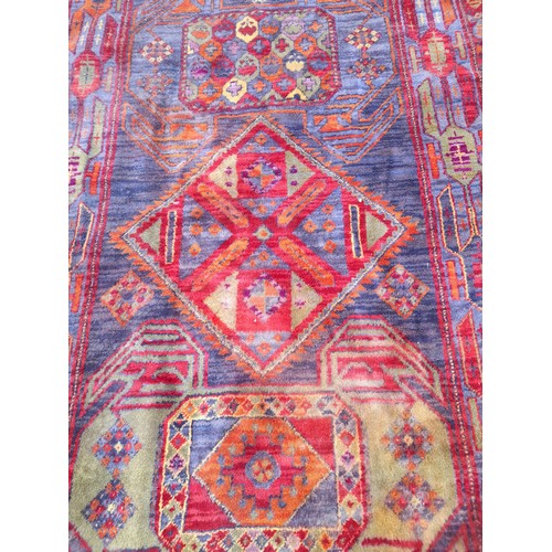 79 - Multi coloured wool rug. 210cm x 127cm