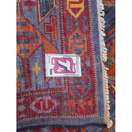 79 - Multi coloured wool rug. 210cm x 127cm