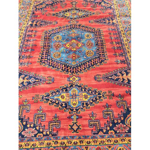 87 - Handmade Red Ground Rug with Blue Ground Central Motif, 250cm x 184cm