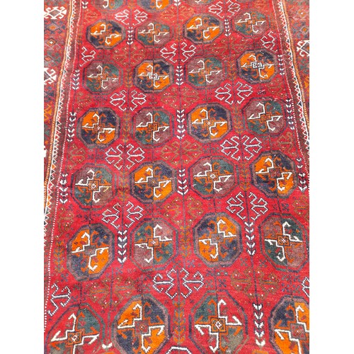 82 - Handmade in Iran, Red ground Rug. 230cm x 116cm