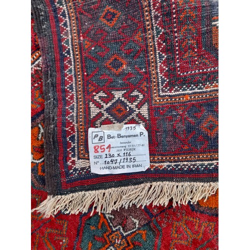 82 - Handmade in Iran, Red ground Rug. 230cm x 116cm