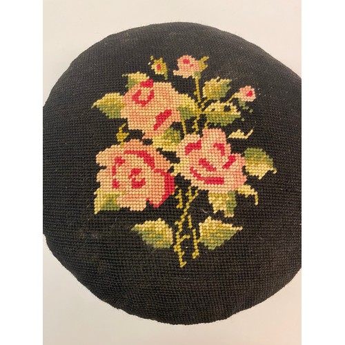 20 - Antique Needlepoint Circular Footstool Black With Floral Design. 29cm Diameter 18cm Height