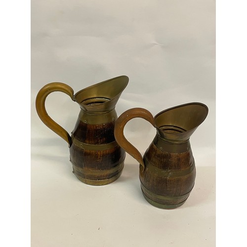 275 - 2 x Continental Metal Bound Wooden Wine Jugs
22 cms High (2)