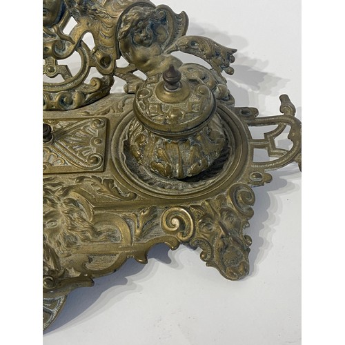 231 - Vintage Brass Art Nouveau Inkwell With Repousse of Faces and Cherubs. 32cm Length