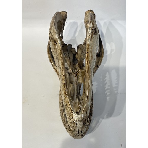 105 - Faux Dinosaur Skull . 39cm x 29cm x 17cm. No 2733