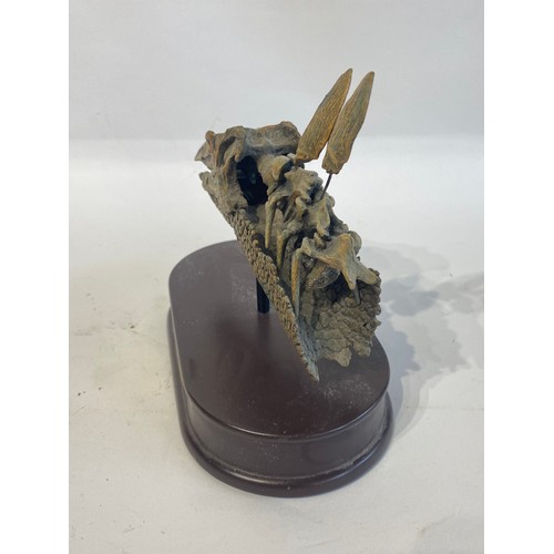 109 - Reproduction Quarter Scale Stegosaurus Skull Mounted On  Wooden Plinth. 21cm x 20cm x 13cm