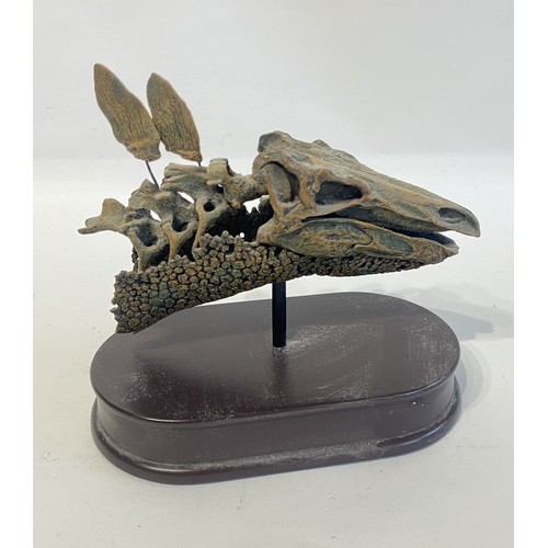 109 - Reproduction Quarter Scale Stegosaurus Skull Mounted On  Wooden Plinth. 21cm x 20cm x 13cm