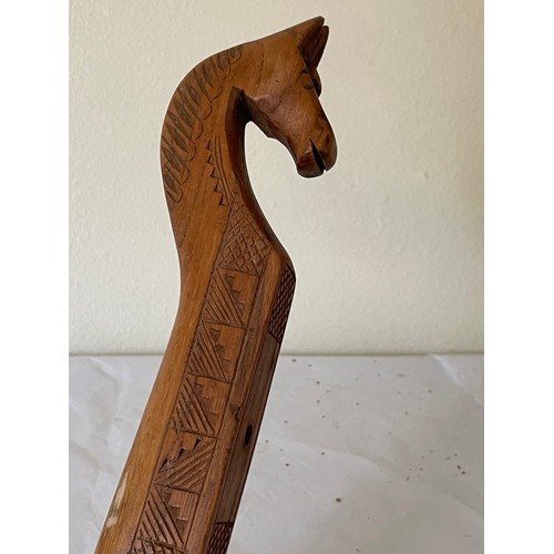 218 - Carved Wood Musical Instrument With Horse Head Finial. 65 cms