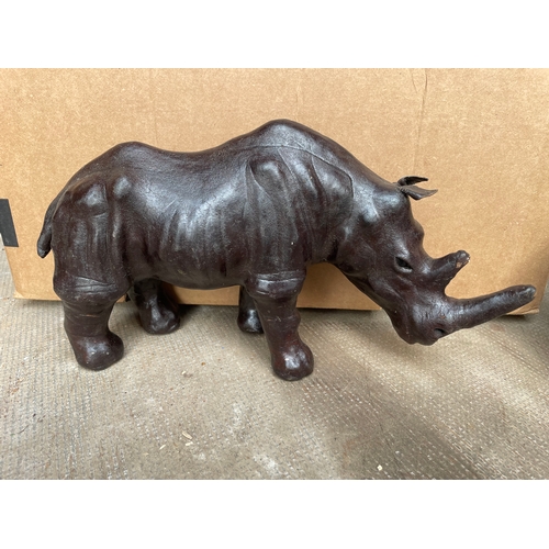 631 - A Leather Clad Rhinoceros Figure. 38 x 19cms