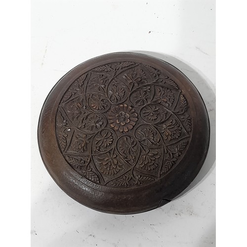 30 - Circular wooden box, profusely carved to both sides, 12cm diameter