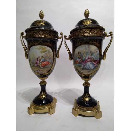 309 - A Pair of Serves Marked Porcelain Urns 43cm high with romantic scenes on each