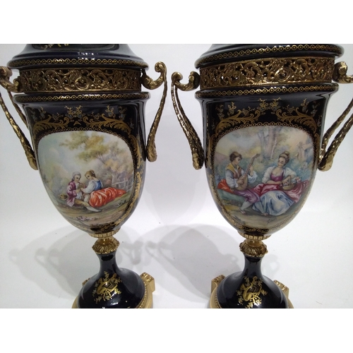 309 - A Pair of Serves Marked Porcelain Urns 43cm high with romantic scenes on each