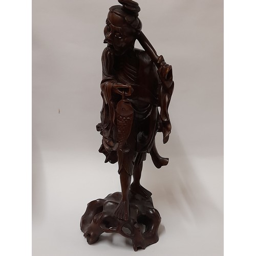 220 - Chinese Root Carving of a Fisherman carrying a Carp, 44cm high