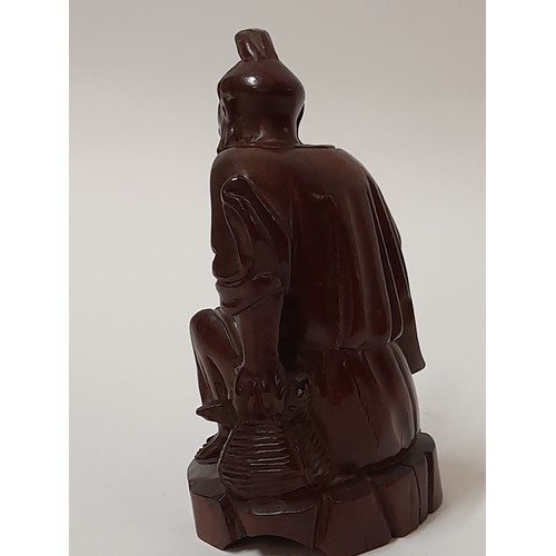 223 - Wood Carved Oriental Immortal smoking a pipe, 13cm high