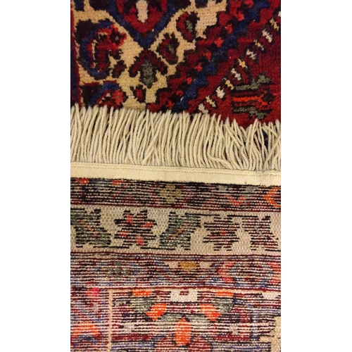 142 - Red ground hand knotted rug, 133cm x 100cm