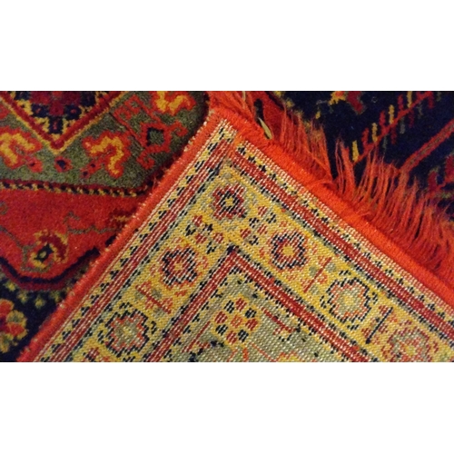 135A - Red ground hand knotted rug, 139cm 87cm