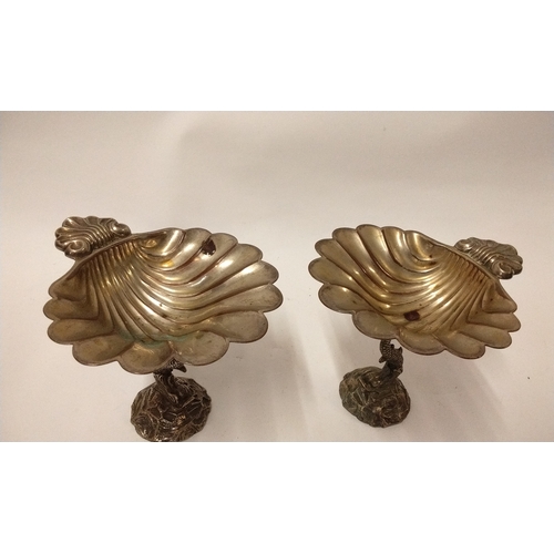 313 - Pair of epns silver dishes in the form of a Scalloped shell with thumb piece raised on a dolphin sta... 