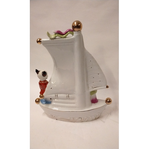 324 - Chinese ceramic model of a Junk with 2 men on board 40cm high x 33cm long