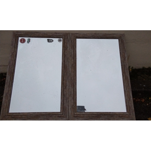 689 - A pair of mirrors in rustic finish wood frames, each mirror 80cm x 120cm