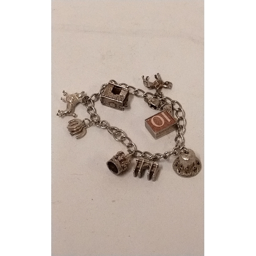 773 - Silver charm bracelet with 9 silver charms