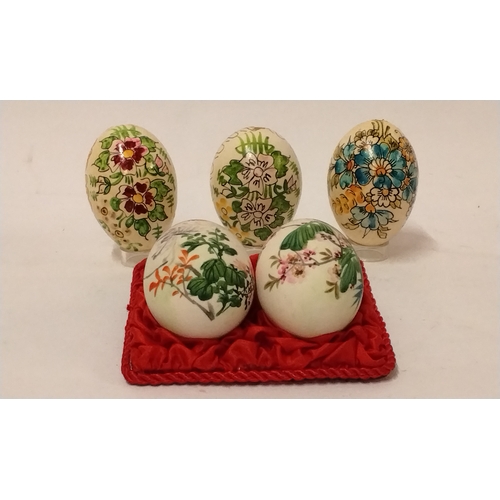 782 - 3 x hand painted eggs with 2 x Ceramic hand painted eggs on a fabric mount. (5)