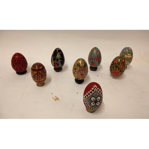 824 - Collection of decorated eggs mostly ceramic all approximately 8cm high