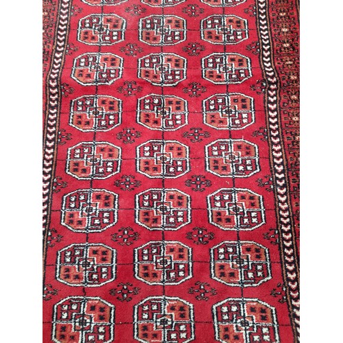 81 - Hand Made Indian Red ground Rug with Geometric design, 164cm x 93cm