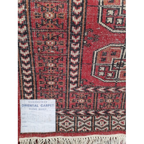 81 - Hand Made Indian Red ground Rug with Geometric design, 164cm x 93cm