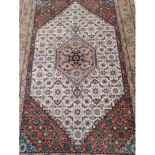 85 - Brown ground oriental rug with central motif, 181cm x 124cm