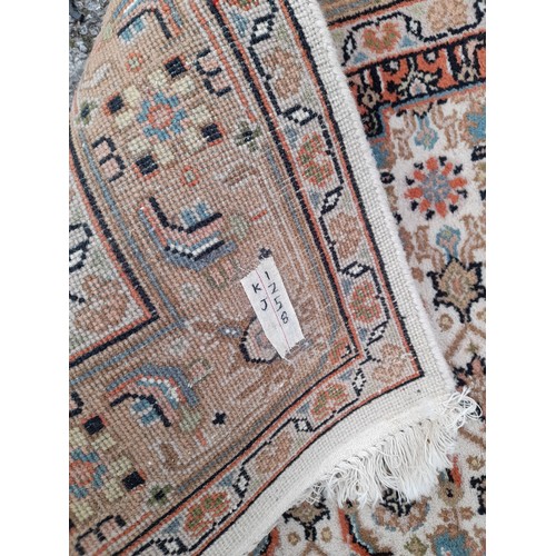 85 - Brown ground oriental rug with central motif, 181cm x 124cm