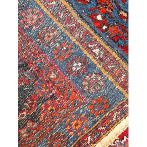 91 - Hand Tied Blue and red ground Rug with central Diamond Pattern, 202cm x 135cm