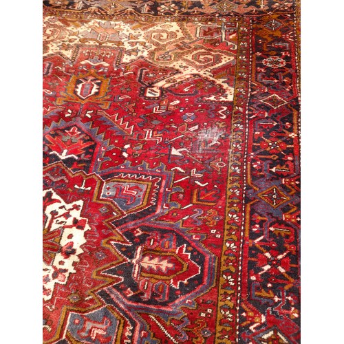 92 - Large Hand Tied Red Ground Rug with Signs Of  Wear, 325cm x 241