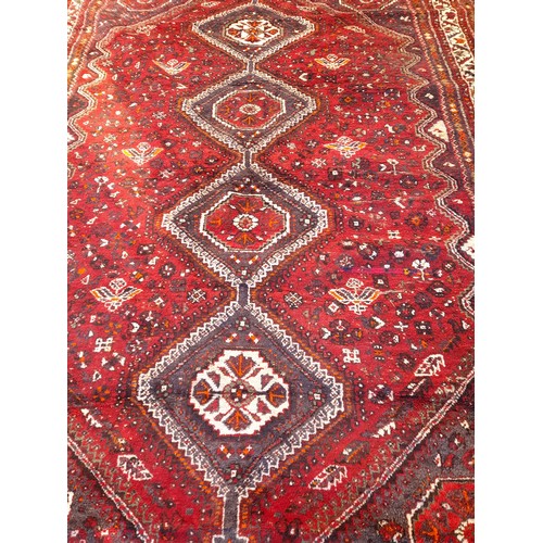 96 - Red ground hand knotted Rug with 4 central diamond pattern,300cm x 204cm