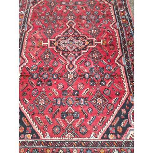 53 - Red ground Rug hand knotted, 210cm x 133cm