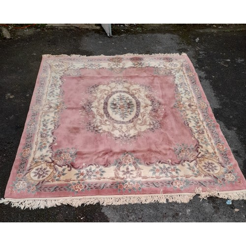 57 - Large oriental pink ground rug with central design, 300cm x 255cm