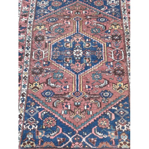 56 - Hand Knotted Red and Blue ground small rug, 138cm x 103cm