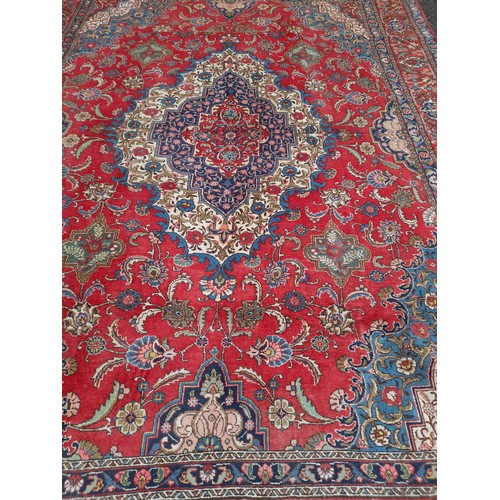 50A - Extra Large Red ground hand knotted Rug with large central motif, 400cm x 300cm