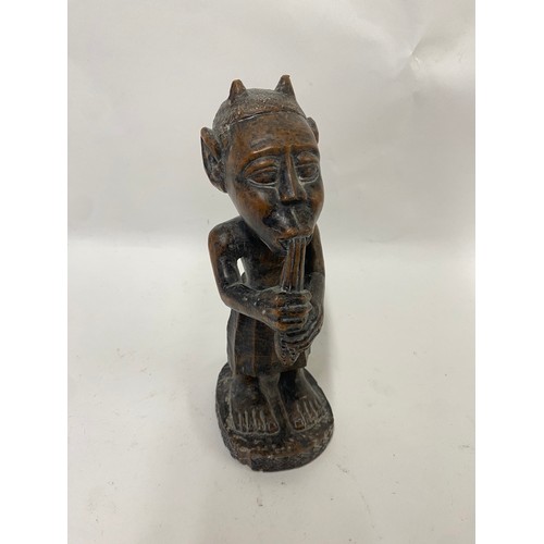 173 - Carved Wooden Tribal Figure of a Man Playing an Instrument 24cm Height