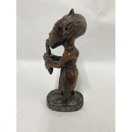 173 - Carved Wooden Tribal Figure of a Man Playing an Instrument 24cm Height