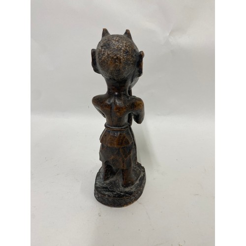 173 - Carved Wooden Tribal Figure of a Man Playing an Instrument 24cm Height