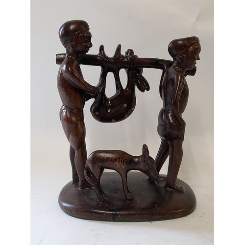 56 - Tribal wood carving of 2 tribesmen carrying their kill,  23cm high x 18cm