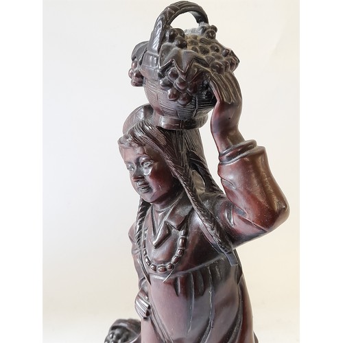 70 - Carved wood Figure of  Pig Tailed Girl carrying a basket of fruit, 31cm tall