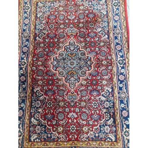 269 - Red Ground small patterned hand knotted rug, 140cm x 78cm