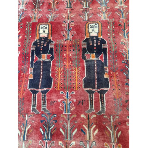 273 - Red Ground Hand Knotted Rug with 2 Figures, 164cm x 115cm