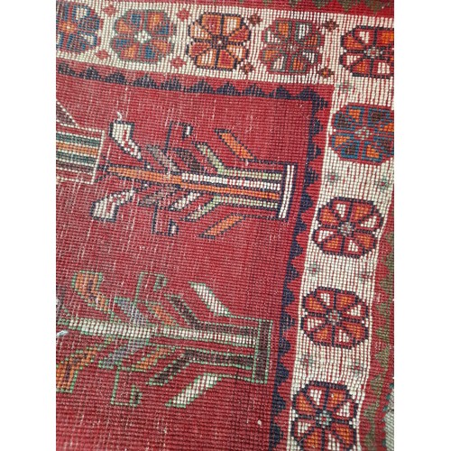 273 - Red Ground Hand Knotted Rug with 2 Figures, 164cm x 115cm