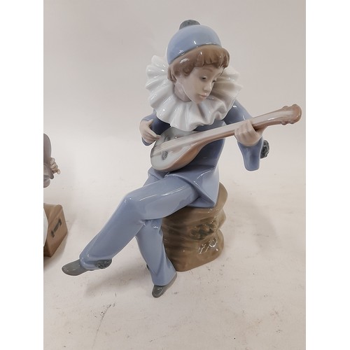 409 - A Lladro Figurine of a Pierrot looking in a mirror with a Nao Figure of a Pierrot strumming an instr... 