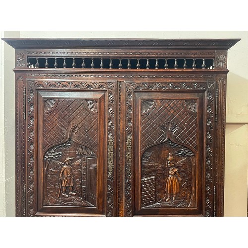 52 - Continental Two Piece Unit With Profusely Carved Panels. 211 x 128 x 42 cms