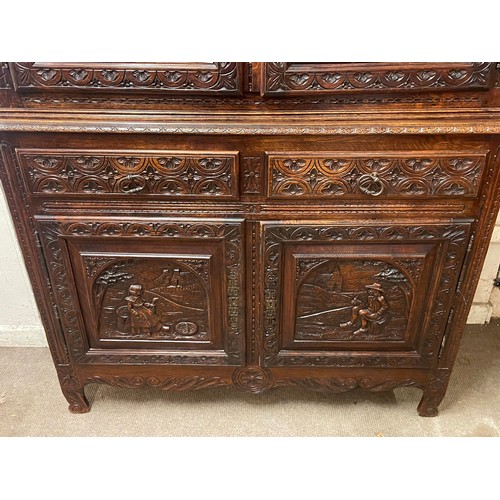 52 - Continental Two Piece Unit With Profusely Carved Panels. 211 x 128 x 42 cms